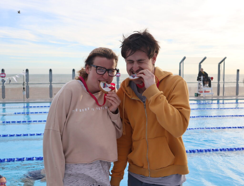 Two people eating their edible medal at Great Lengths.