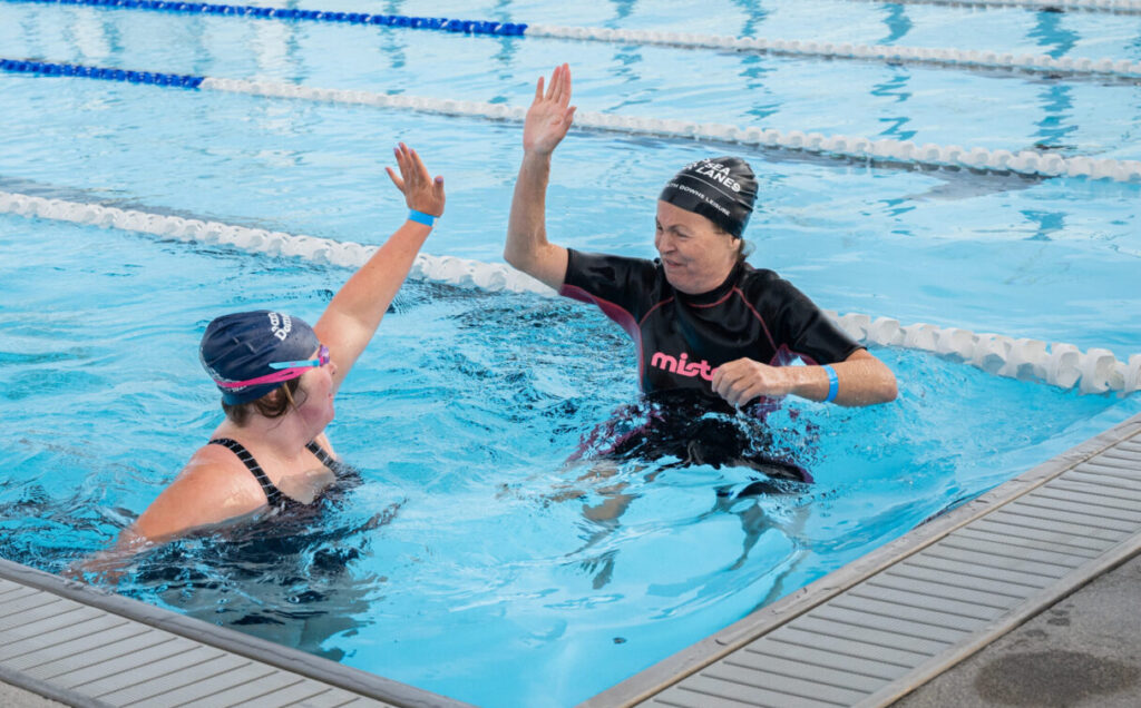 Two swimmers at Great Lengths giving each other a high five