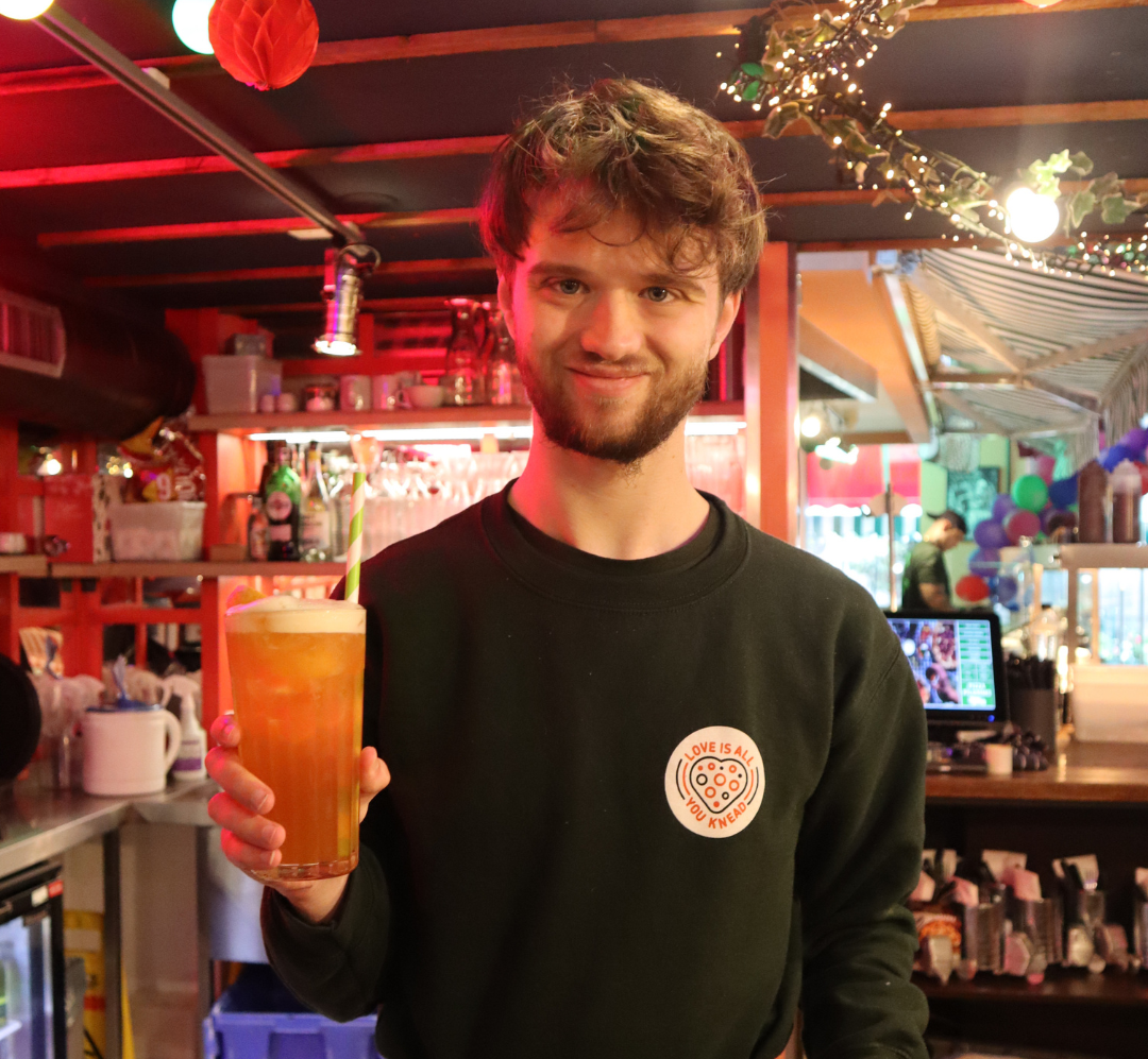 A photo of Theo at his work placement at Pizza Pilgrims Brighton as part of National Supported Internship Day 2024.