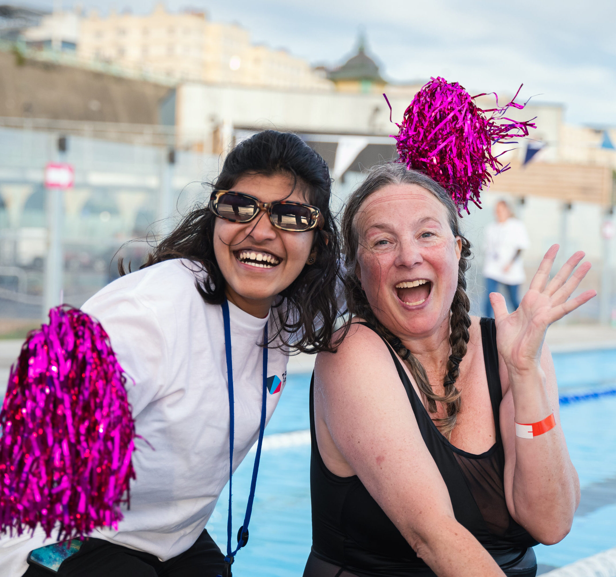 A photo of two people celebrating by the swimming pool at Great Lengths 2024