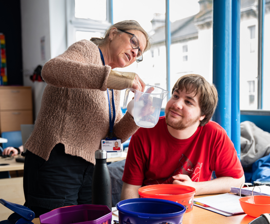 A photo of a candidate working with a teacher int he classroom