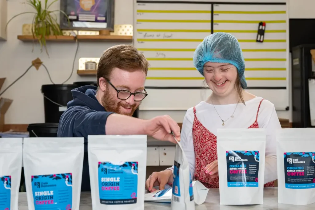 Two Team Domenica candidates working to pack and seal our coffee ready or online orders.