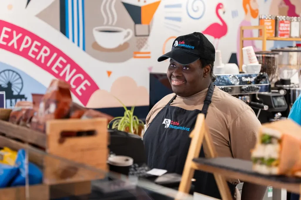 A Team Domenica candidate behind the till at their cafe on Preston Road