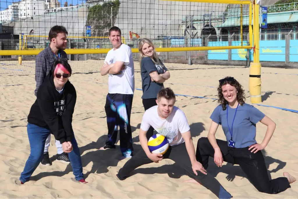 A group of six Team Domenica candidates and staff post together after a fun enrichment session doing volleyball