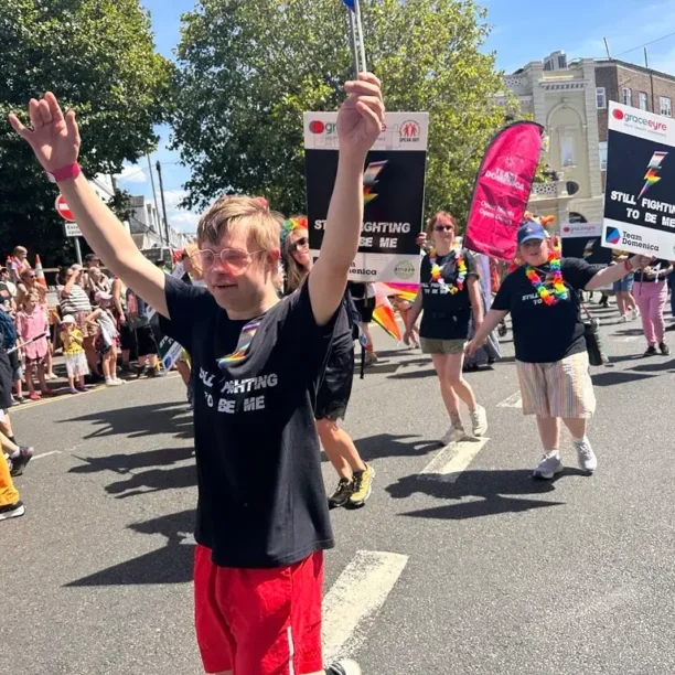 Team Domenica candidate enjoying Brighton Pride 2026 PARADE waving a flag.