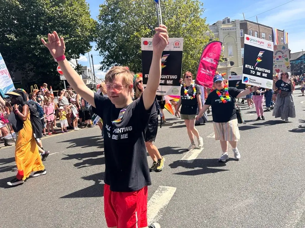 Team Domenica candidate enjoying Brighton Pride 2026 PARADE waving a flag.